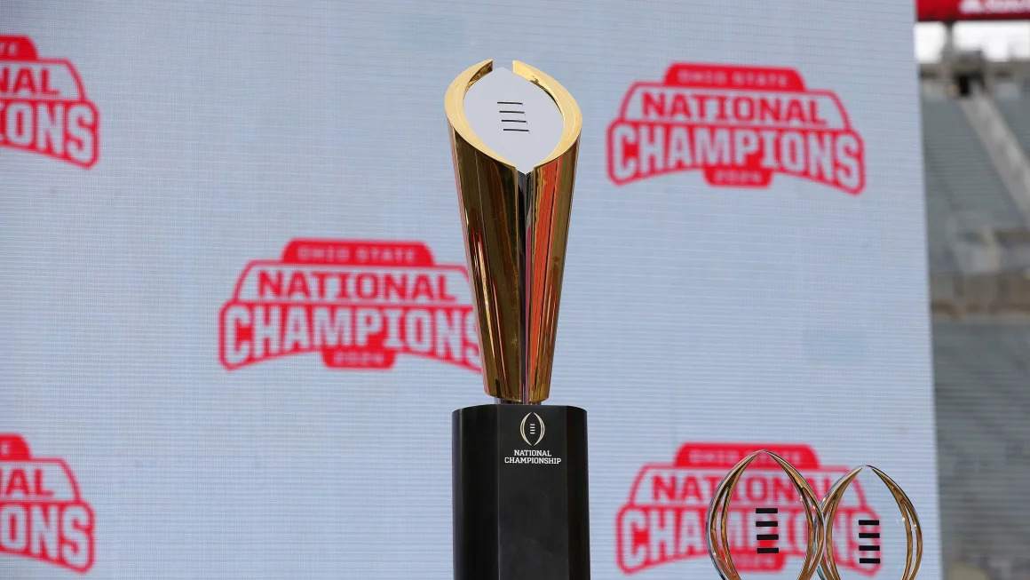 College Football Playoff logo on the field with players lined up for kickoff